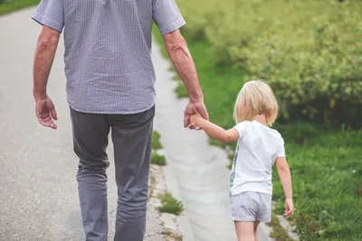 Father holding daughter's hand